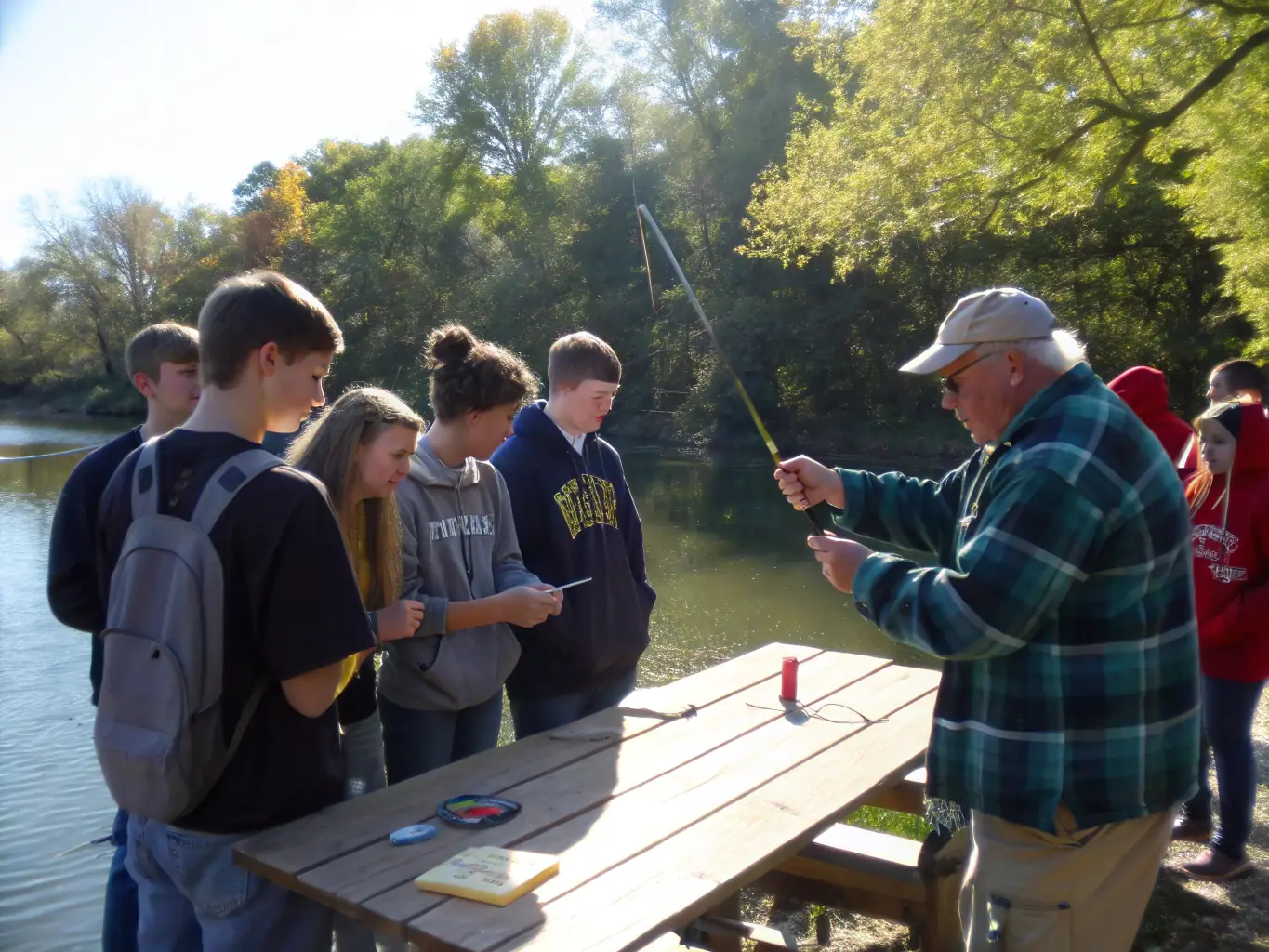 A group of children participating in a fishing workshop, demonstrating A.A.P.P.M.A LA GAULE LAMBALLAISE's commitment to educating the next generation about responsible fishing.